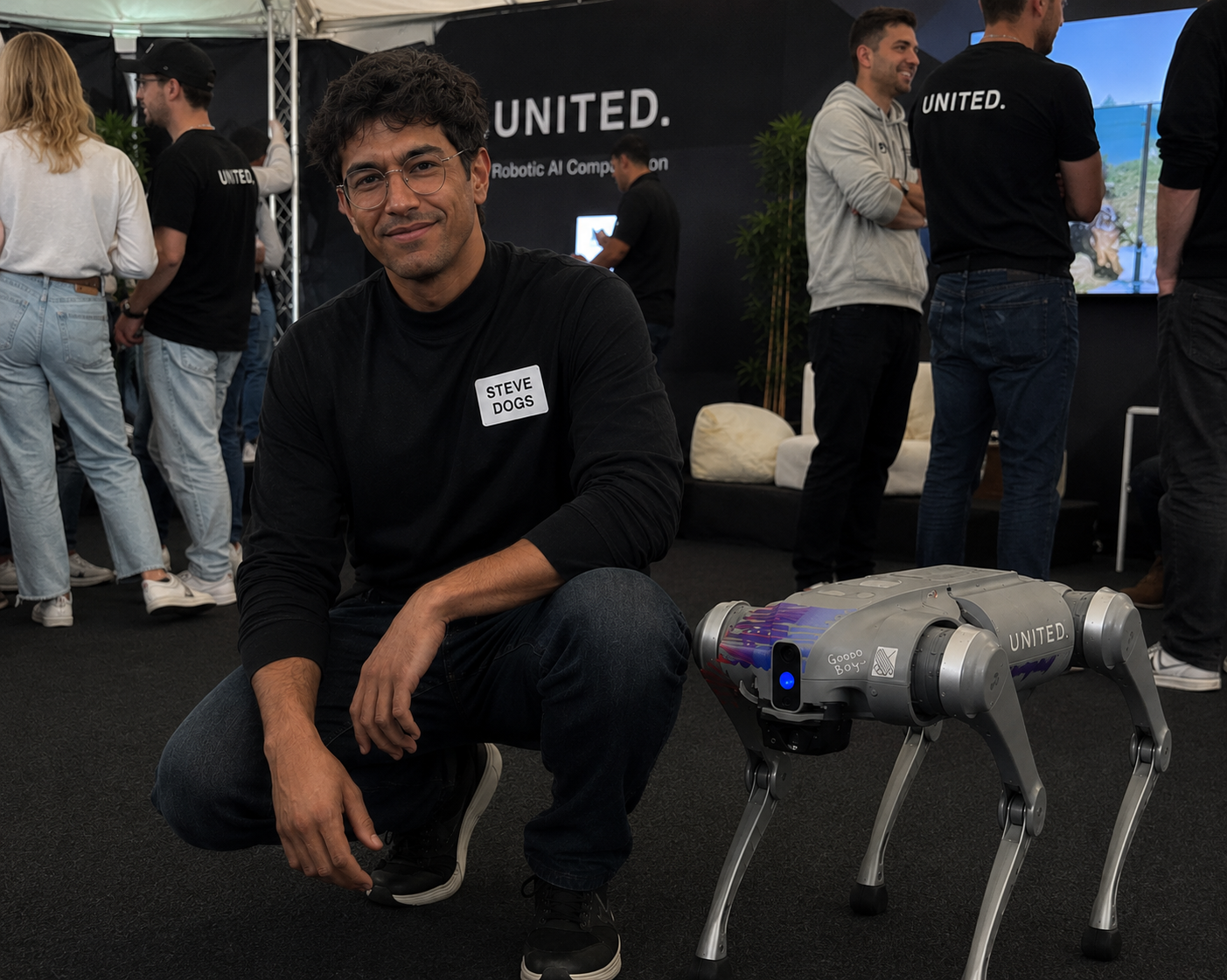 Steve Dogs wearing his name tag beside a robot dog